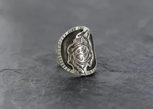 Saddle ring with howling wolf and paw design  in sterling silver