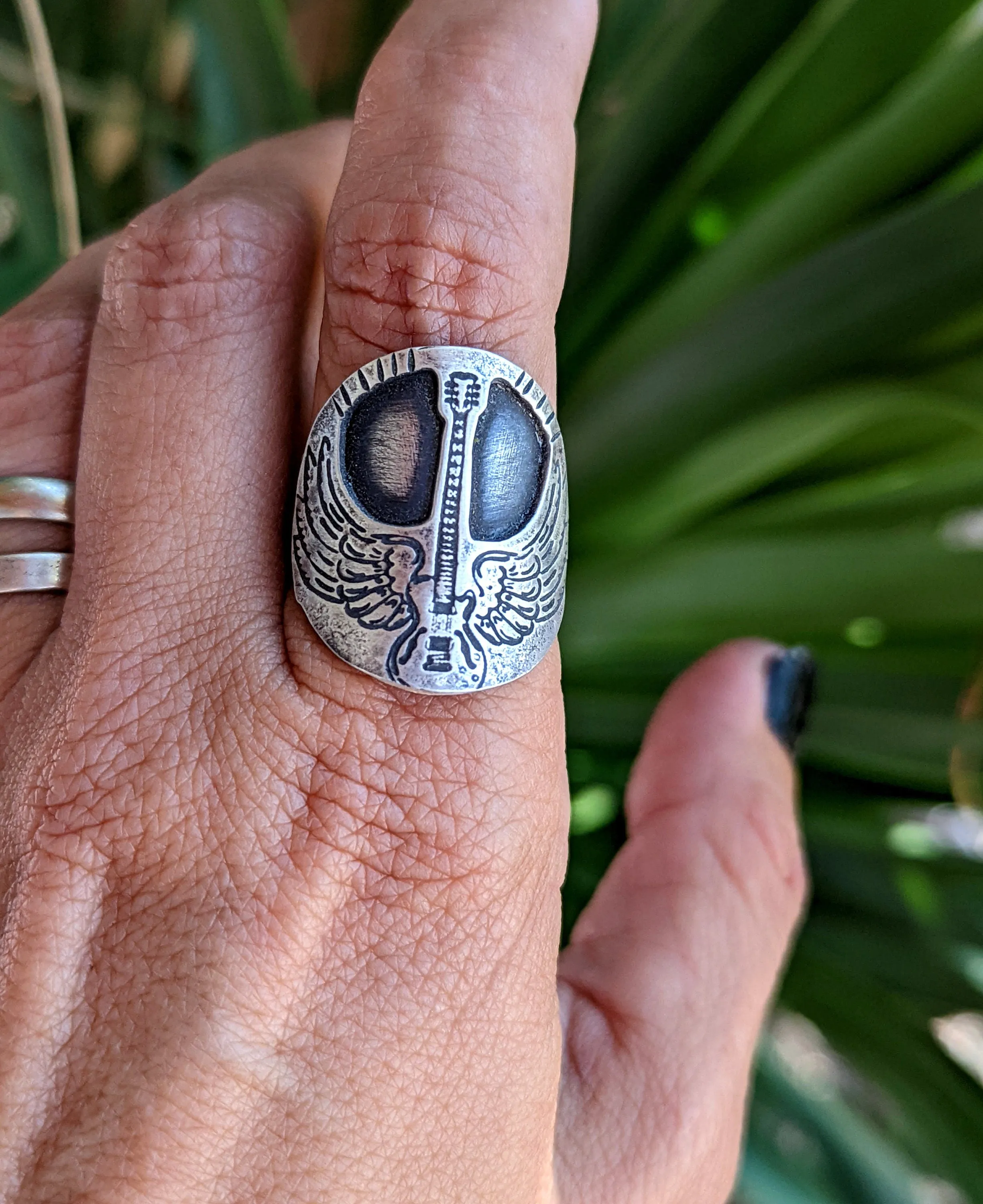 Winged guitar on  sterling silver saddle ring